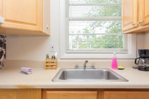 a kitchen counter with a sink and a window at Las Olas Studio - 5 minutes from Las Olas Beach in Fort Lauderdale