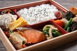 a tray of food with rice and vegetables at HOTEL MYSTAYS Ueno Iriyaguchi in Tokyo