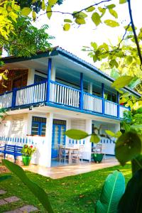a blue and white house with a table and chairs at Esperanza Beach Mawella in Tangalle