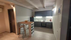 a small kitchen with a table and a counter at GIORGIO LUXURY LOFT WITH AMAZING VIEW Of NAFPLIO in Nafplio