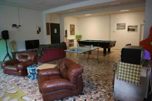 a living room with couches and a pool table at Cave Trieste Apartments - CaTs Apartments in Tarvisio