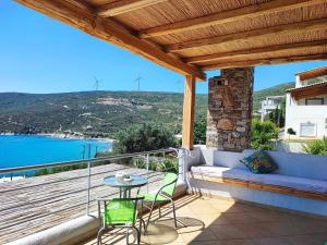 a patio with a table and chairs on a balcony at Seagulls - Within walking distance from sea! in Petriaí