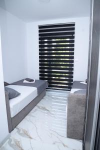 Postelja oz. postelje v sobi nastanitve ITACA apartman Krupanj