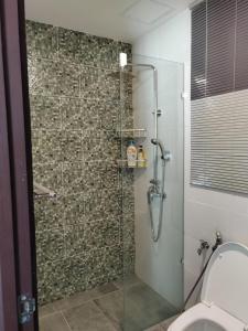 a bathroom with a glass shower with a toilet at Viva city Jazz3 Homestay Near Tabuan Jaya in Kuching