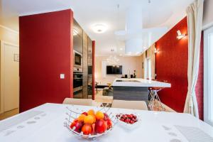 
a kitchen with a table, a sink, and a refrigerator at Suites One in Zadar
