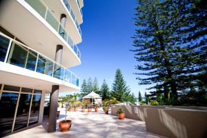 a building with a large tree in front of it at Club Wyndham Port Macquarie in Port Macquarie