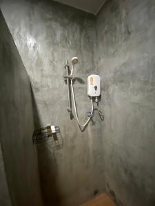 a bathroom with a soap dispenser on the wall at Zabit Bungalow in Ko Lanta