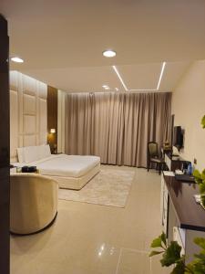 a hotel room with a bed and a couch at Clifton International Hotel in Fujairah