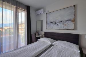 Postelja oz. postelje v sobi nastanitve Hotel Luna Garni