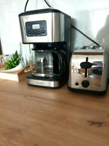 a coffee maker and a toaster sitting on a counter at Enjoy BDF in Vatra Dornei