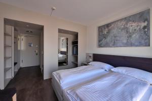 Postelja oz. postelje v sobi nastanitve Hotel Luna Garni