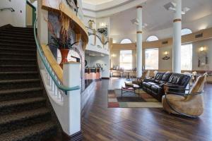 a living room with a couch and a stair case at Puffin Inn in Anchorage