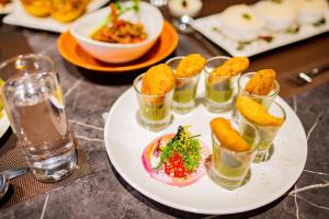 una tavola ricoperta di piatti di cibo e bicchieri d'acqua di The Imperial Inn a Siliguri