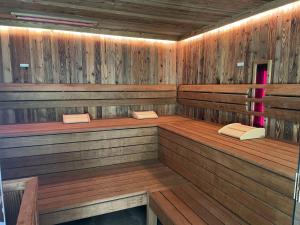 a sauna with two books sitting in the middle at Chalet Glemmerl Mountain Lodge Saalbach Hinterglemm in Saalbach Hinterglemm