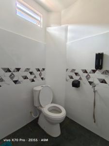 a bathroom with a white toilet in a room at ASM Roomstay-4-2 Queen Beds in Kuala Terengganu