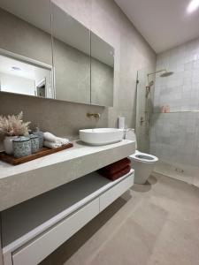 a bathroom with a sink and a toilet at 12 Stern Way New Gisborne in Gisborne