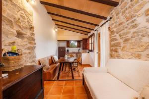 a living room with a couch and a table at Es Sestador in Petra
