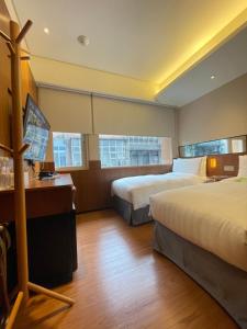 Postel nebo postele na pokoji v ubytování 盤古捷旅 - Panco Hotel