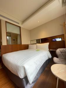 Postel nebo postele na pokoji v ubytování 盤古捷旅 - Panco Hotel