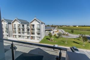 a view from the balcony of a apartment building at Modern 3 Bedroom Near The Beachfront in Summerstrand