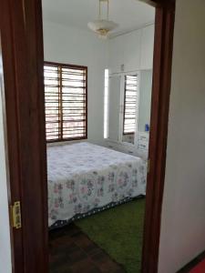 a bedroom with a bed and two windows at Fiji-Beauty in Nadi
