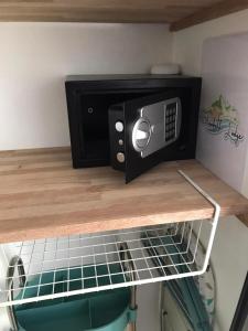 a microwave oven sitting on top of a shelf at Elisabeth Lodge Vairupe in Bora Bora