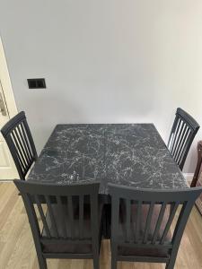 a black table and chairs with a black marble table and chairs at Tas Homes Antalya in Antalya