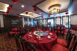 a dining room with red tables and chairs at Sabah Hotel in Sandakan +66 photos