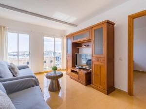 a living room with a couch and a tv at Mahostly Corralejo Vista Mar in Corralejo