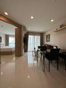 a living room with a table and a couch at City Garden Tropicana Condo Naklua in Pattaya North