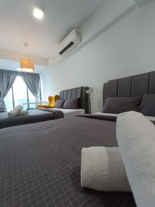 a bedroom with two beds and a couch and a couch at CL 93B Balcony KLCC View Studio in Kuala Lumpur