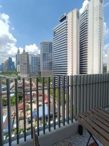 a bench on a balcony with a view of a city at CL 93B Balcony KLCC View Studio in Kuala Lumpur