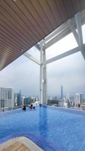 a large swimming pool on the roof of a building at CL 93B Balcony KLCC View Studio in Kuala Lumpur