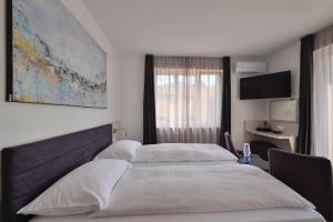 Postelja oz. postelje v sobi nastanitve Hotel Luna Garni