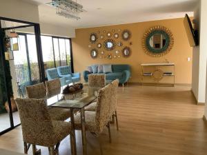 a living room with a table and chairs and a couch at Modern apartment with concierge in Miraflores in Lima