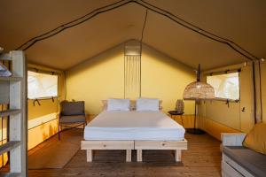 a bedroom with a bed in a tent at Layla Glamping in Nir Dawid