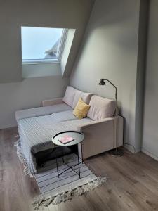 a living room with a couch and a window at Single Elegant Room i sentrum- Sea View in Ålesund