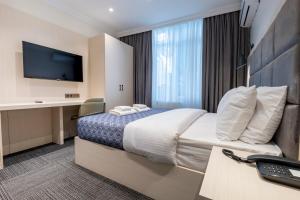 a hotel room with a bed and a desk at Hub Suite Istanbul in Istanbul
