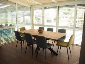 a dining room with a wooden table and chairs at Haus Sonnenschein in Klagenfurt