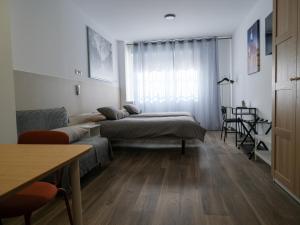 Alianza Suites客房内的一张或多张床位