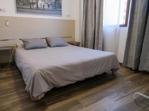 Alianza Suites客房内的一张或多张床位