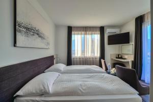 Postelja oz. postelje v sobi nastanitve Hotel Luna Garni