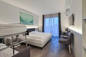 Postelja oz. postelje v sobi nastanitve Hotel Luna Garni