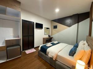a bedroom with a large bed and a television at Assalam Hotel in Kota Bharu