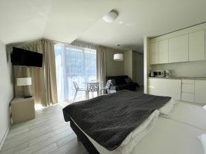 a bedroom with a bed and a living room at Apartament Ischgl 35 in Sienna +3 photos