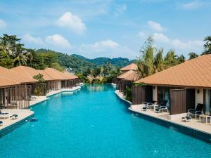 a swimming pool at a resort with blue water at Blue Bay Resort - Access to Pool and Beach-Phuket & Krabi in Ko Yao Yai
