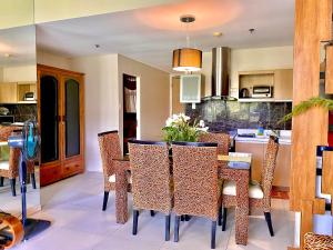 a kitchen with a table and chairs in a room at Pico De Loro 2BR Carola B Unit with Lagoon View in Nasugbu +37 photos