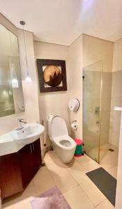a bathroom with a toilet and a sink at Pico De Loro 2BR Carola B Unit with Lagoon View in Nasugbu