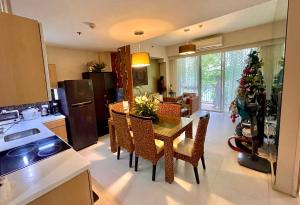 a kitchen and dining room with a table and chairs at Pico De Loro 2BR Carola B Unit with Lagoon View in Nasugbu
