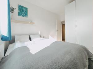 a white bedroom with two white beds in it at Dobrego Pasterza 120D by Homeprime in Kraków